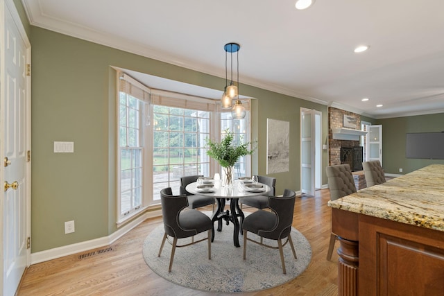 1111 Chickasaw Dr, Brentwood, TN 37027 - dining room featuring ornamental molding, a brick fireplace, light wood-style flooring, and recessed lighting