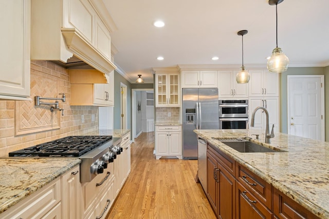 1111 Chickasaw Dr, Brentwood, TN 37027 - kitchen with stainless steel appliances, crown molding, glass insert cabinets, light wood finished floors, and backsplash