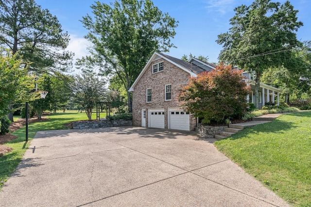1111 Chickasaw Dr, Brentwood, TN 37027 - view of property exterior with concrete driveway, a garage, brick siding, and a yard