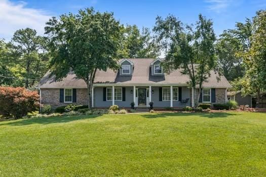 1111 Chickasaw Dr, Brentwood, TN 37027 - new england style home with a front yard and covered porch