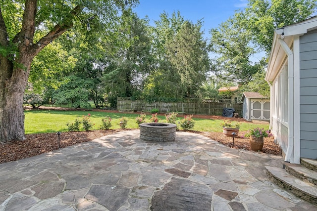 1111 Chickasaw Dr, Brentwood, TN 37027 - fenced backyard featuring a storage unit, a patio area, and a fire pit