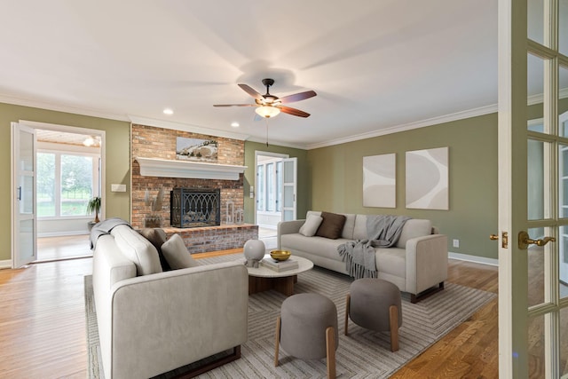 1111 Chickasaw Dr, Brentwood, TN 37027 - living room featuring ceiling fan, light wood-type flooring, a fireplace, and crown molding