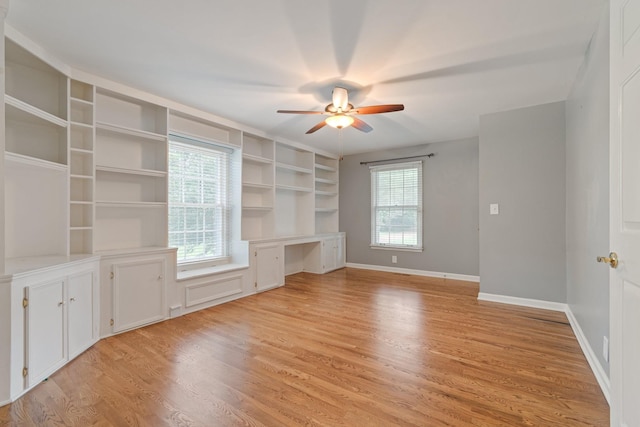 1111 Chickasaw Dr, Brentwood, TN 37027 - unfurnished living room featuring built in desk, a ceiling fan, light wood-style flooring, and healthy amount of natural light