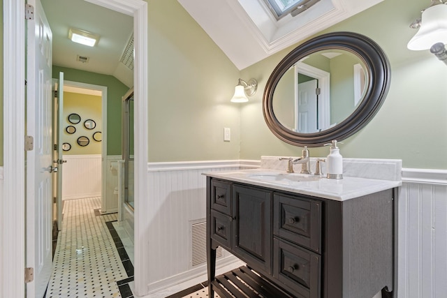 1111 Chickasaw Dr, Brentwood, TN 37027 - bathroom featuring wainscoting, a skylight, an enclosed shower, vanity, and vaulted ceiling