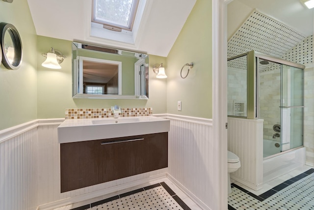 1111 Chickasaw Dr, Brentwood, TN 37027 - full bathroom with wainscoting, shower / bath combination with glass door, vanity, a skylight, and tile patterned flooring