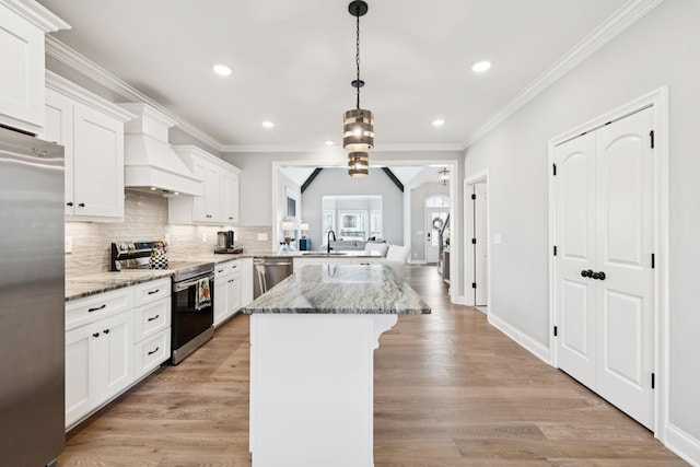 1037 Jackston Mack Way, Gallatin, TN 37066 - kitchen with appliances with stainless steel finishes, custom range hood, a breakfast bar, recessed lighting, and white cabinetry