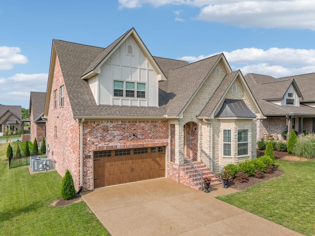 1037 Jackston Mack Way, Gallatin, TN 37066 - view of front facade featuring a garage, a front lawn, driveway, a shingled roof, and brick siding