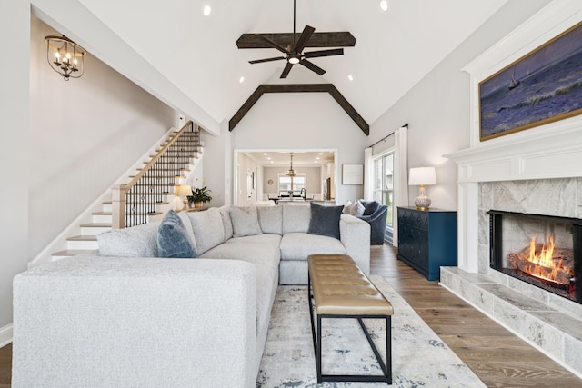 1037 Jackston Mack Way, Gallatin, TN 37066 - living room with a chandelier, stairs, a premium fireplace, high vaulted ceiling, and wood finished floors