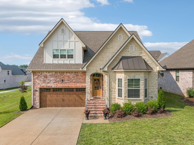 1037 Jackston Mack Way, Gallatin, TN 37066 - view of front of home featuring an attached garage, a front yard, a shingled roof, concrete driveway, and stone siding