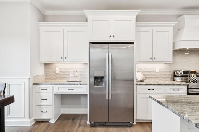 1037 Jackston Mack Way, Gallatin, TN 37066 - kitchen featuring stainless steel appliances, custom range hood, light wood finished floors, white cabinets, and crown molding