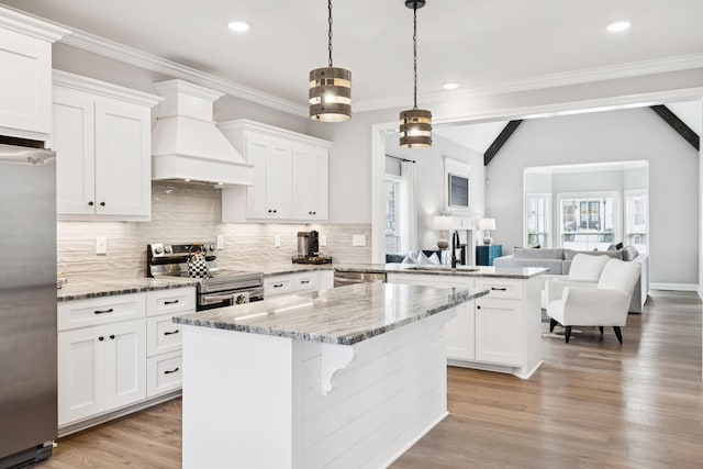 1037 Jackston Mack Way, Gallatin, TN 37066 - kitchen with stainless steel appliances, custom exhaust hood, a peninsula, open floor plan, and tasteful backsplash