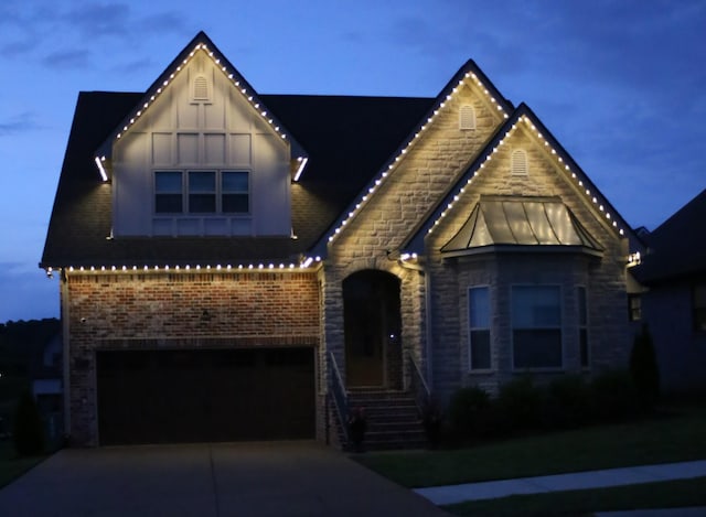1037 Jackston Mack Way, Gallatin, TN 37066 - view of front of home with concrete driveway, an attached garage, stone siding, a standing seam roof, and brick siding