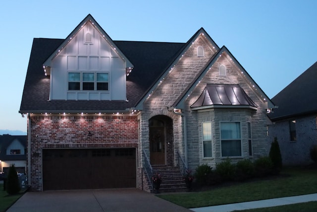 1037 Jackston Mack Way, Gallatin, TN 37066 - view of front facade featuring concrete driveway, stone siding, a garage, a standing seam roof, and brick siding