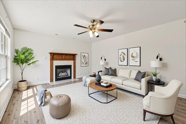 853 Hornbuckle Rd, Clarksville, TN 37043 - living area with wood finished floors, ceiling fan, and a fireplace with flush hearth