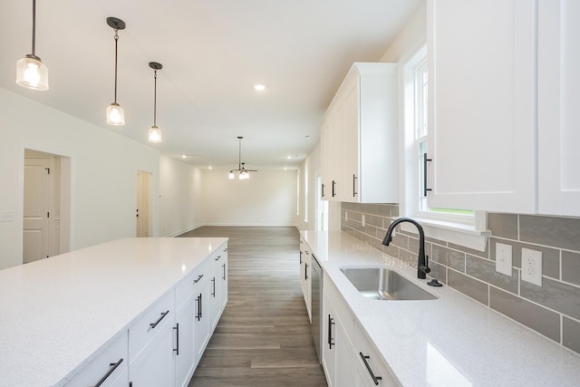4022 Rampart Way, Spring Hill, TN 37174 - kitchen featuring dark wood-style floors, decorative backsplash, white cabinetry, hanging light fixtures, and light stone countertops