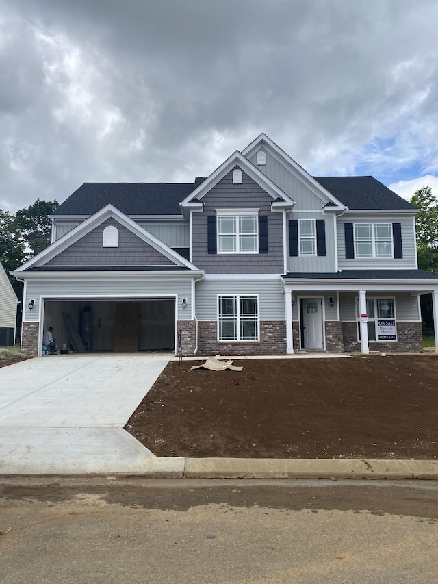 4022 Rampart Way, Spring Hill, TN 37174 - craftsman-style house with a garage, covered porch, driveway, stone siding, and board and batten siding