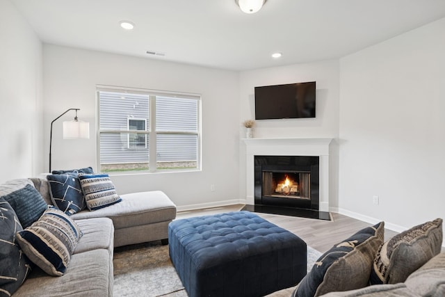 3276 Holiday Ln, Columbia, TN 38401 - living room with a warm lit fireplace, wood finished floors, and recessed lighting