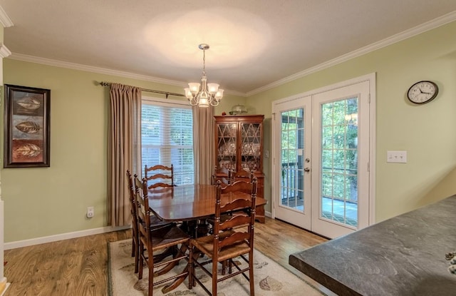 730 Carlew Rd, Waynesboro, TN 38485 - dining space with light wood-style flooring, a chandelier, crown molding, and healthy amount of natural light