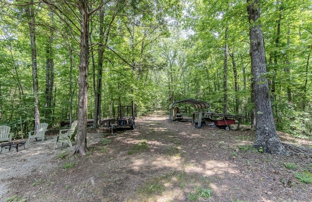 730 Carlew Rd, Waynesboro, TN 38485 - view of yard featuring a forest view and a carport