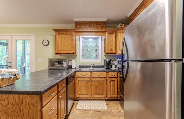 730 Carlew Rd, Waynesboro, TN 38485 - kitchen with stainless steel appliances, a peninsula, ornamental molding, dark countertops, and light wood-style floors