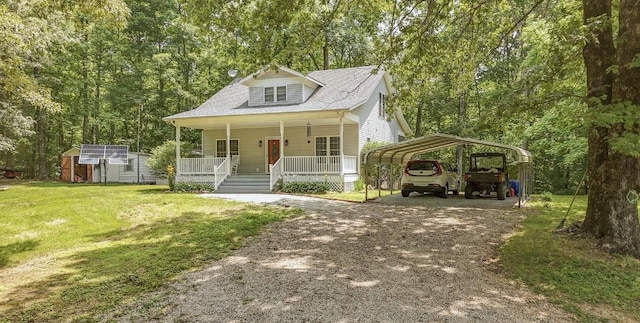730 Carlew Rd, Waynesboro, TN 38485 - view of front of home featuring a porch, driveway, a front yard, a detached carport, and a storage shed