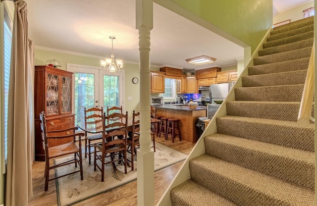 730 Carlew Rd, Waynesboro, TN 38485 - dining room featuring light wood finished floors, ornamental molding, stairway, a chandelier, and french doors