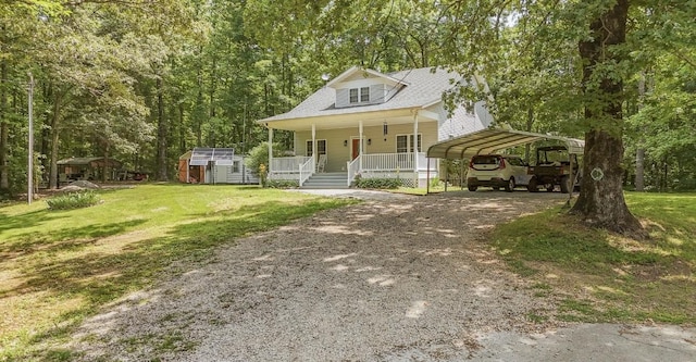 730 Carlew Rd, Waynesboro, TN 38485 - view of front facade with a porch, driveway, a storage unit, a detached carport, and a front lawn