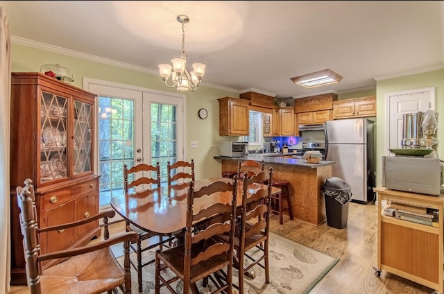 730 Carlew Rd, Waynesboro, TN 38485 - dining area with crown molding, light wood-type flooring, french doors, and a chandelier