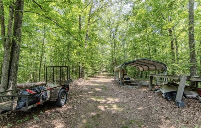 730 Carlew Rd, Waynesboro, TN 38485 - view of yard featuring a forest view, a detached carport, and dirt driveway