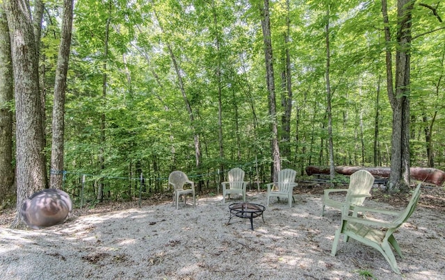 730 Carlew Rd, Waynesboro, TN 38485 - view of patio with an outdoor fire pit and a view of trees