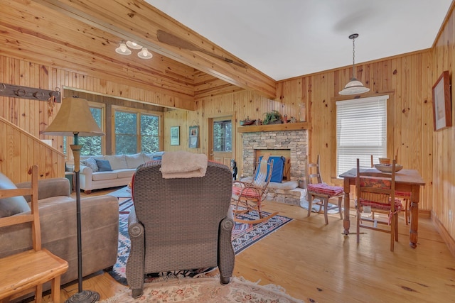 110 Village Way, Lancaster, TN 38569 - living room featuring plenty of natural light, wood walls, wood finished floors, and a stone fireplace