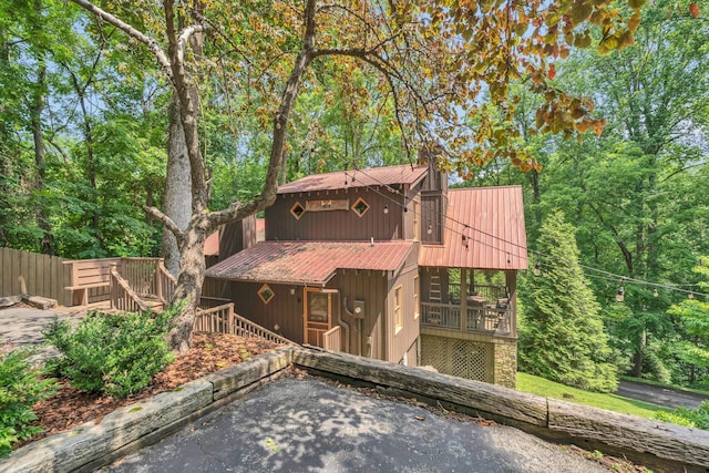 110 Village Way, Lancaster, TN 38569 - view of front of property with a metal roof, a wooden deck, and a chimney