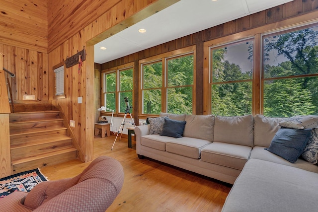 110 Village Way, Lancaster, TN 38569 - living room featuring wood walls, stairway, and light wood-style floors