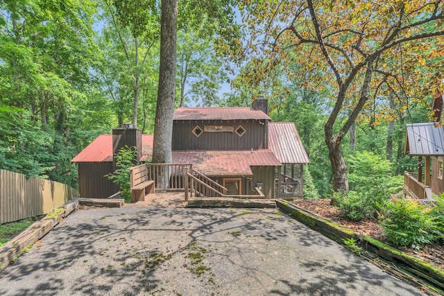 110 Village Way, Lancaster, TN 38569 - view of front of home featuring a chimney, a metal roof, and stairway