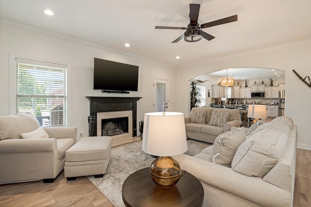 2018 Via Francesco Ct, Spring Hill, TN 37174 - living room with arched walkways, ceiling fan, light wood finished floors, ornamental molding, and recessed lighting