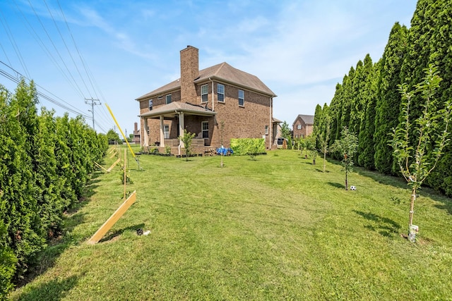 2018 Via Francesco Ct, Spring Hill, TN 37174 - rear view of house featuring brick siding, a chimney, and a lawn
