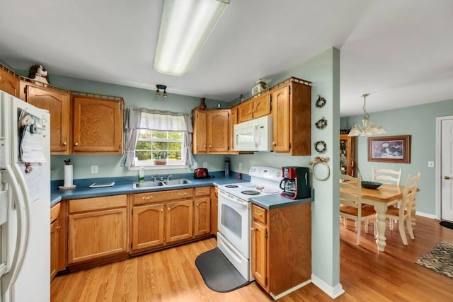 1611 London Dr, Columbia, TN 38401 - kitchen with white appliances, light wood-type flooring, a chandelier, and dark countertops