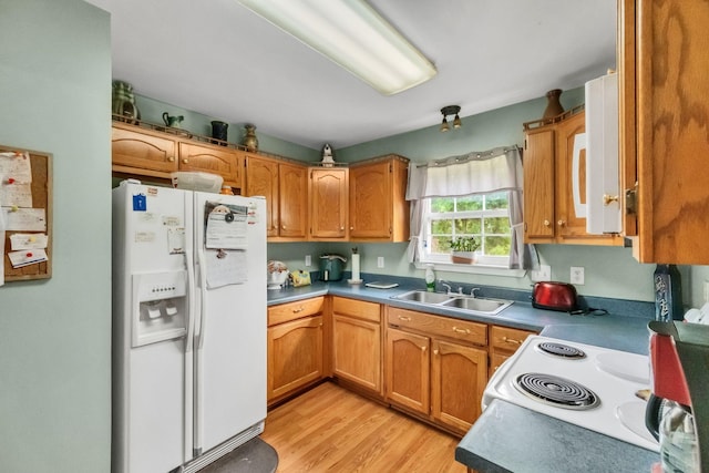 1611 London Dr, Columbia, TN 38401 - kitchen featuring white appliances, light wood-style flooring, and brown cabinetry