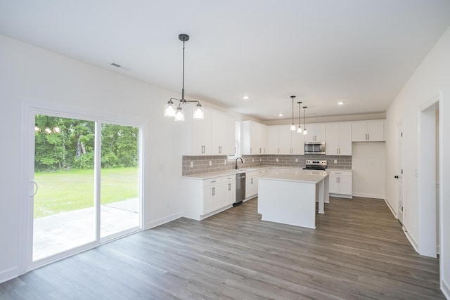 4018 Rampart Way, Spring Hill, TN 37174 - kitchen featuring stainless steel appliances, decorative backsplash, light countertops, wood finished floors, and recessed lighting