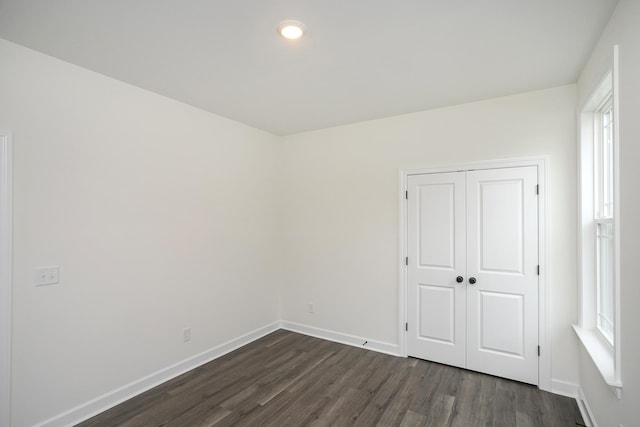 4018 Rampart Way, Spring Hill, TN 37174 - unfurnished bedroom featuring dark wood-style flooring, multiple windows, a closet, and recessed lighting