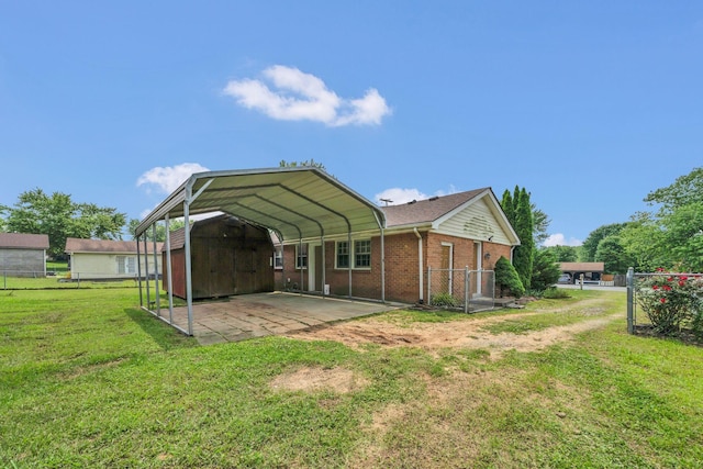 575 Cynthia Dr, Clarksville, TN 37042 - rear view of house with a carport, brick siding, and driveway