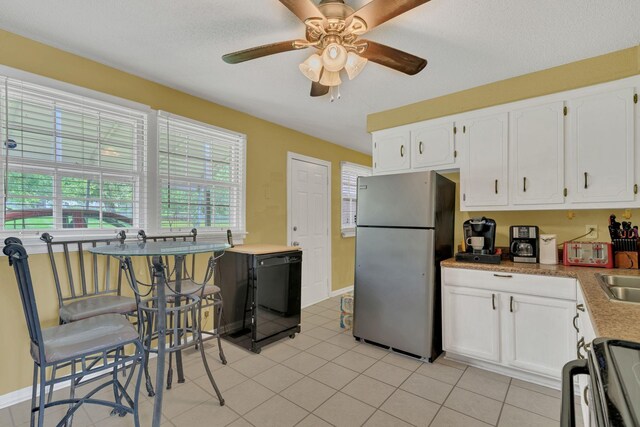 575 Cynthia Dr, Clarksville, TN 37042 - kitchen featuring freestanding refrigerator, dishwasher, white cabinets, a ceiling fan, and light tile patterned floors