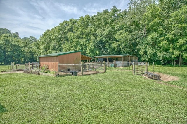 1034 Gaw Branch Rd, Gainesboro, TN 38562 - view of yard featuring an exterior structure, an outdoor structure, and a wooded view