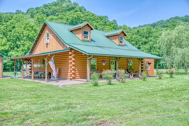 1034 Gaw Branch Rd, Gainesboro, TN 38562 - log home with log exterior, covered porch, a front yard, and a forest view