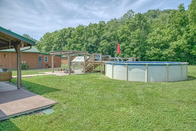 1034 Gaw Branch Rd, Gainesboro, TN 38562 - view of green lawn featuring an outdoor pool, a view of trees, and an outbuilding