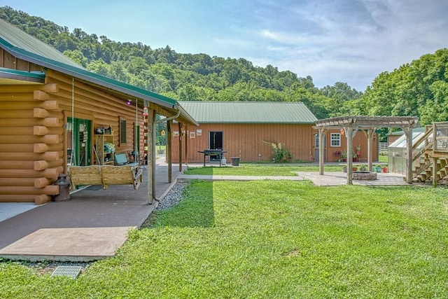 1034 Gaw Branch Rd, Gainesboro, TN 38562 - view of green lawn featuring a pergola, an outbuilding, a patio, and an exterior structure