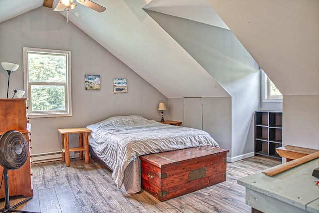 1034 Gaw Branch Rd, Gainesboro, TN 38562 - bedroom featuring wood finished floors, multiple windows, vaulted ceiling, and a baseboard heating unit