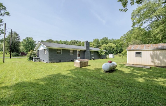 5011 Sunny Acres Dr, Waynesboro, TN 38485 - rear view of house with a chimney, crawl space, a yard, and brick siding