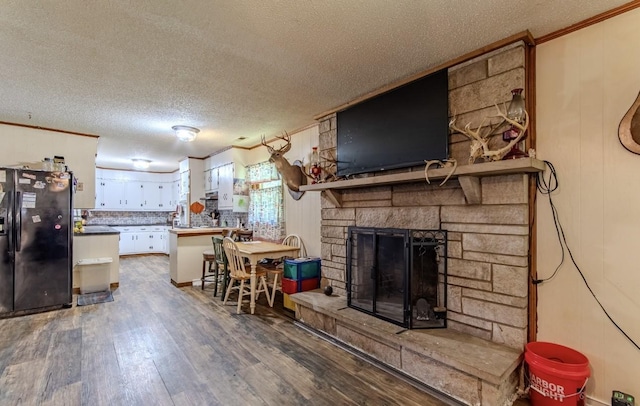 5011 Sunny Acres Dr, Waynesboro, TN 38485 - living room with crown molding, wood finished floors, a textured ceiling, and a fireplace