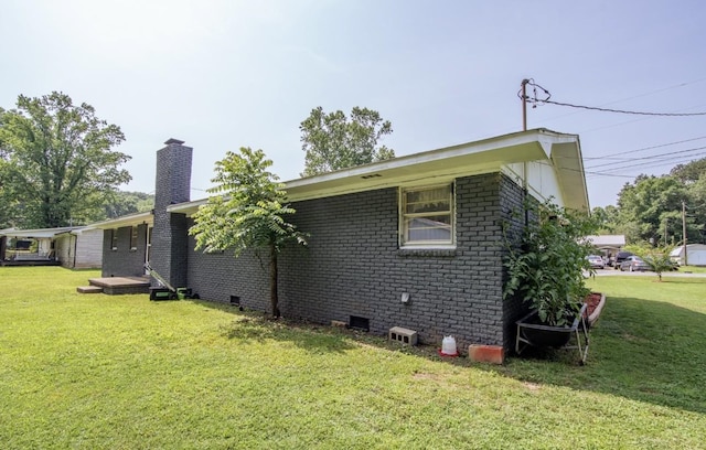 5011 Sunny Acres Dr, Waynesboro, TN 38485 - view of property exterior featuring a chimney, a lawn, and brick siding